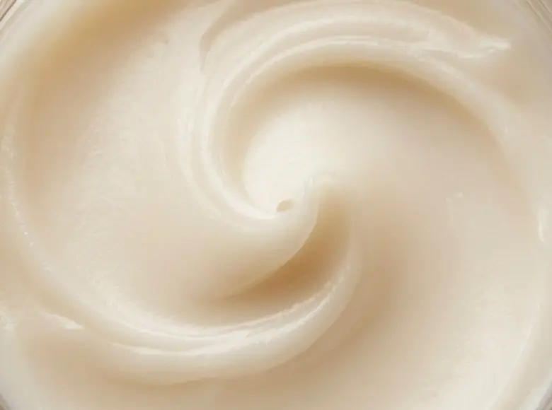 Close detail of the Nerida's Skin Aid balm surface, a soft ivory swirl